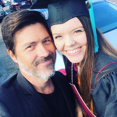 Kyan is in a suit and Morgan is wearing her graduation dress.